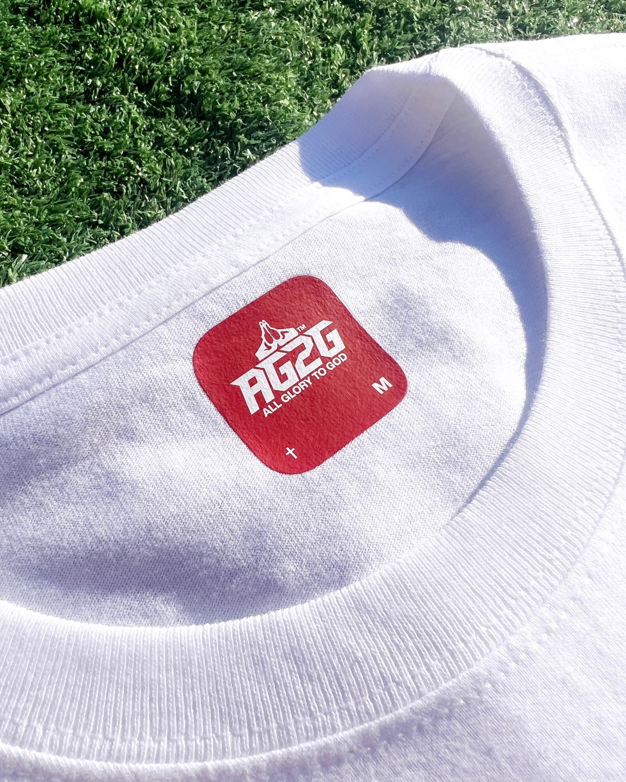 Christian Apparel: All Glory To God ‘OG Logo’ T-Shirt in White featuring bold lettering. Perfect for Christian t-shirts, Christian streetwear, and Christian athletic wear fans seeking faith-inspired style and comfort.
