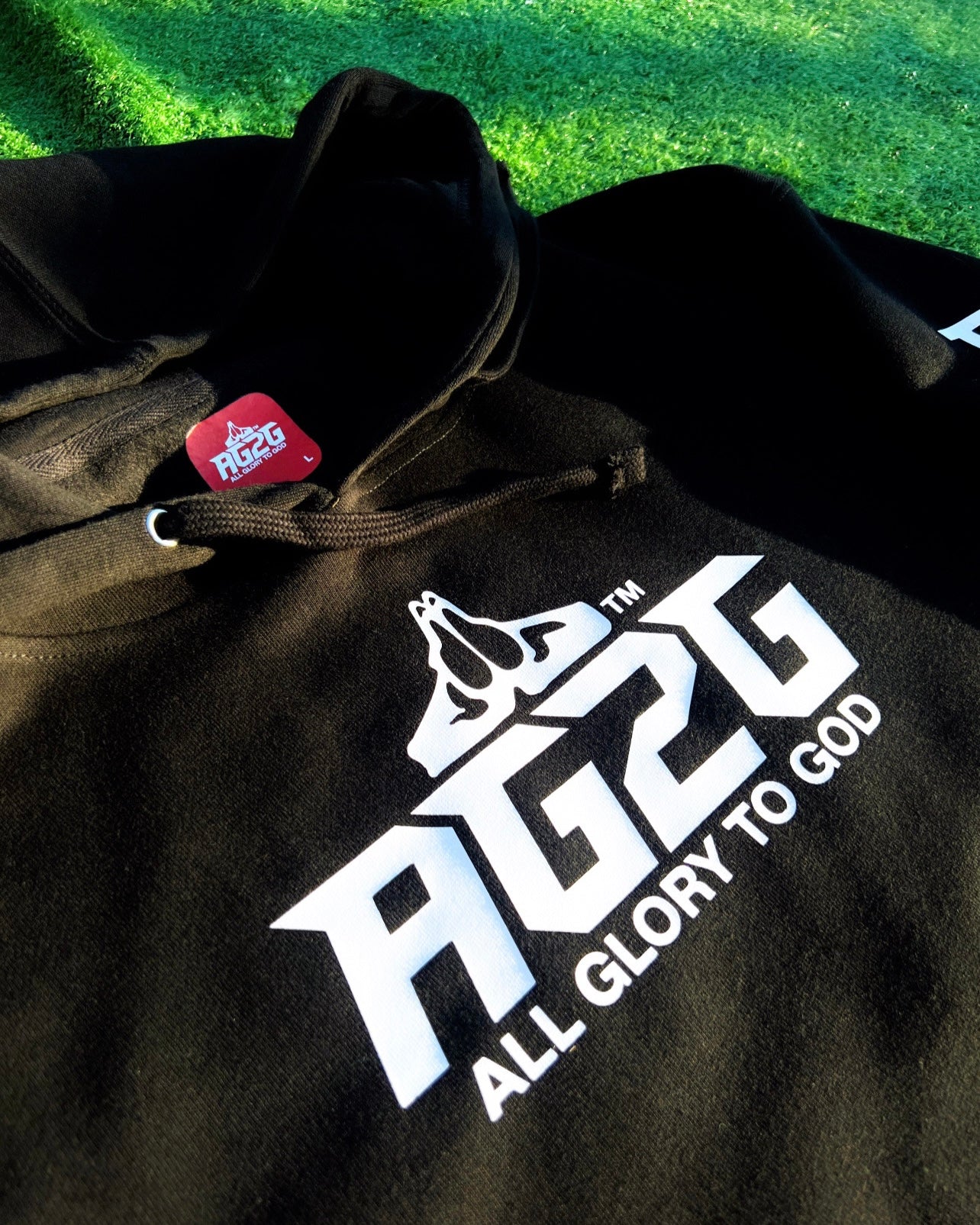 Christian Apparel: All Glory To God ‘OG Logo’ Hoodie in Black featuring bold lettering. Perfect for Christian hoodies, Christian streetwear, and Christian athletic wear fans seeking faith-inspired style and comfort.