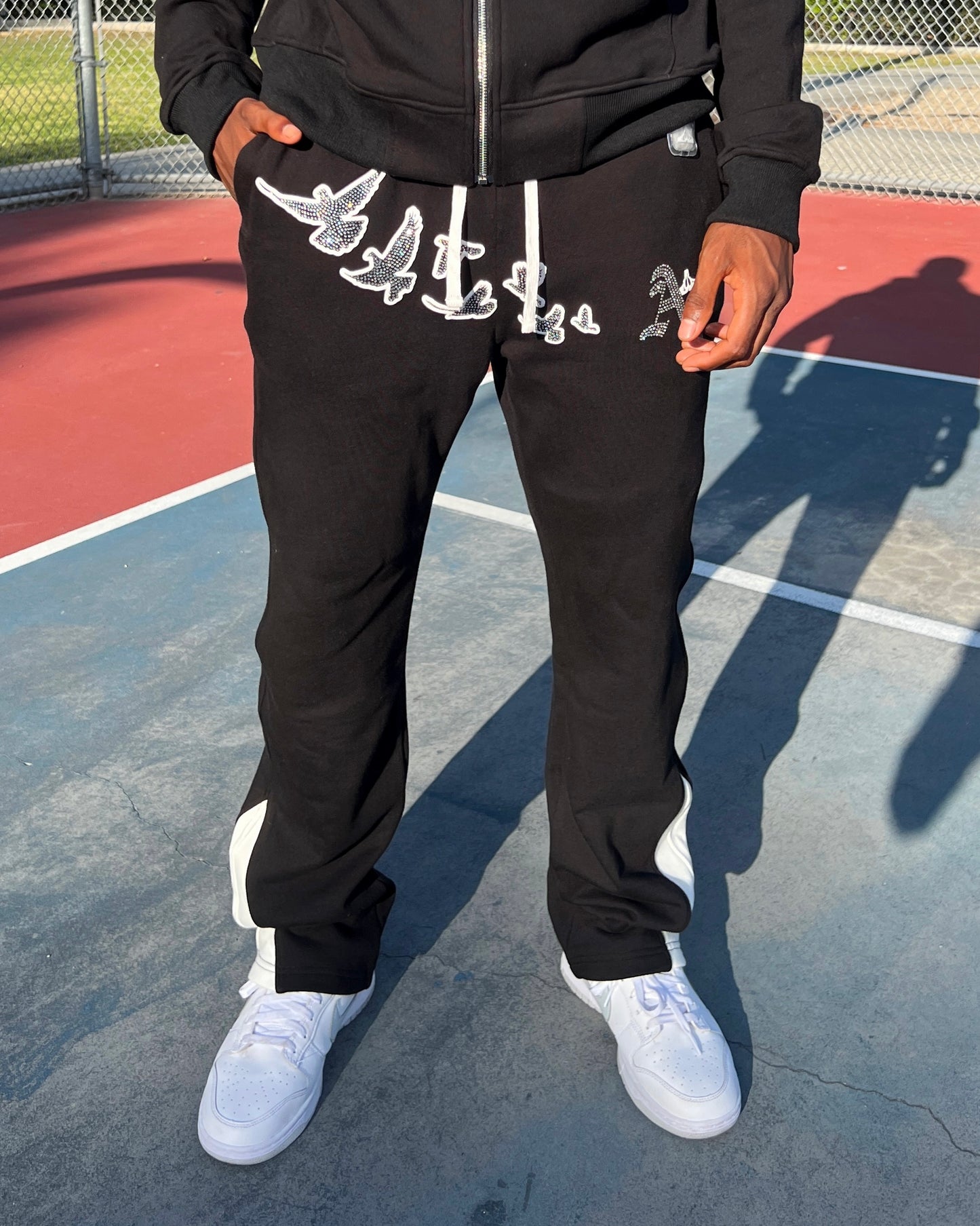 Christian Apparel: All Glory To God ‘Iced Out Flocka Doves’ FlyFleece Flared Sweatpants in Black with dove graphics, bold lettering, and Philippians 4:13. Great for Christian bottoms, Christian streetwear, and Christian athletic wear.