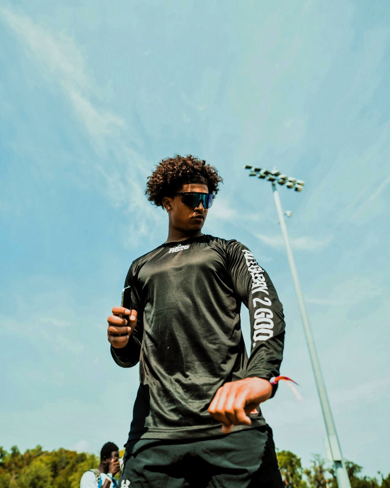 Christian Apparel: All Glory To God ‘Uni’ FlyFit Long Sleeve in Black with football uniform, bold lettering, and Philippians 4:13. Perfect for Christian Long Sleeve T-Shirts, Christian athletic wear, and Christian streetwear.