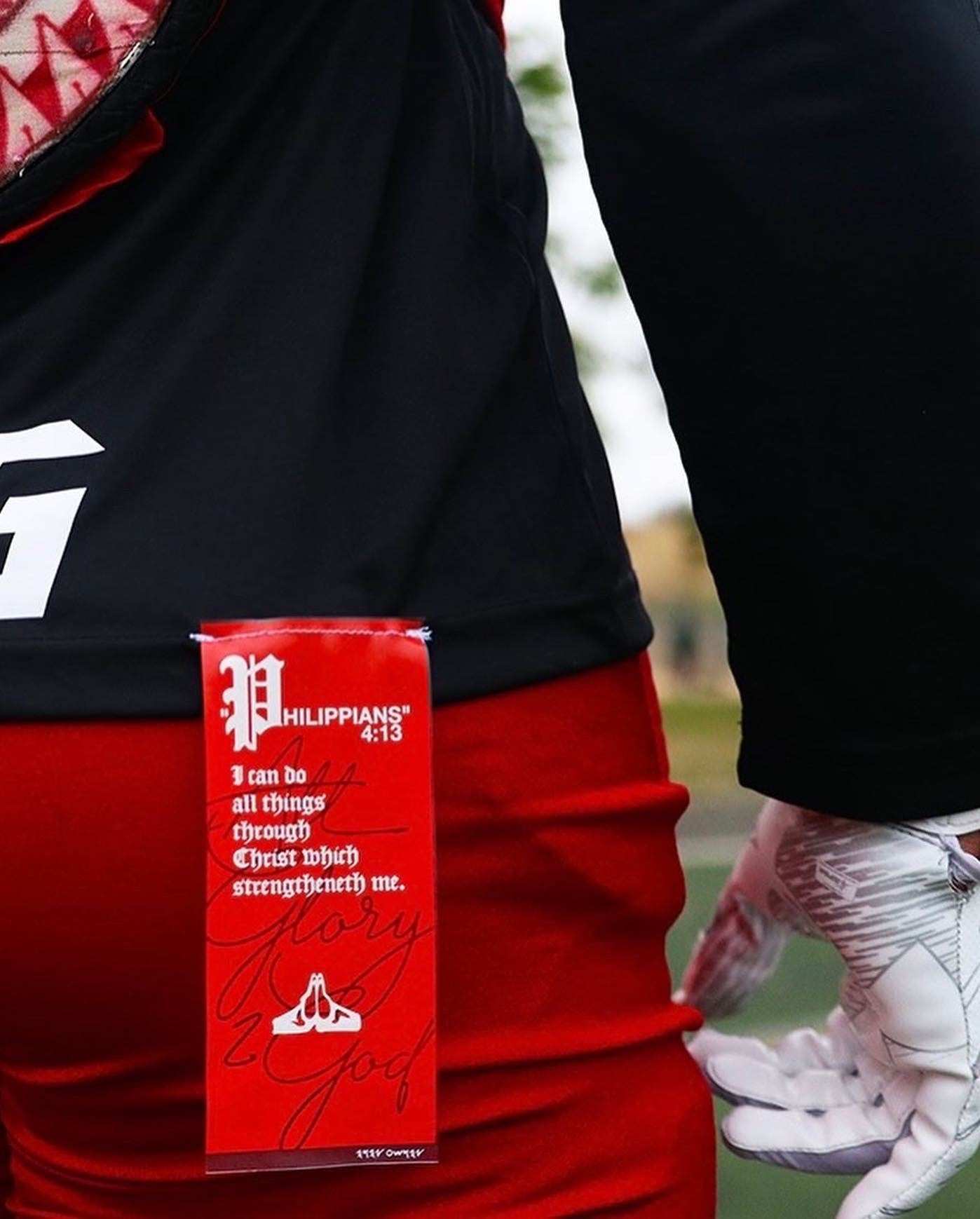 Christian Apparel: All Glory To God ‘Uni’ FlyFit Long Sleeve in Black with football uniform, bold lettering, and Philippians 4:13. Perfect for Christian Long Sleeve T-Shirts, Christian athletic wear, and Christian streetwear.