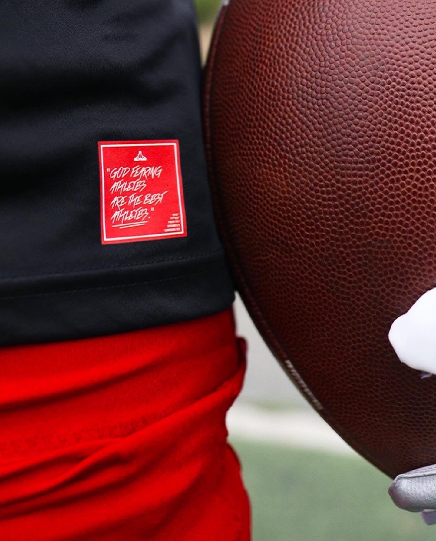 Christian Apparel: All Glory To God ‘Uni’ FlyFit Long Sleeve in Black with football uniform, bold lettering, and Philippians 4:13. Perfect for Christian Long Sleeve T-Shirts, Christian athletic wear, and Christian streetwear.