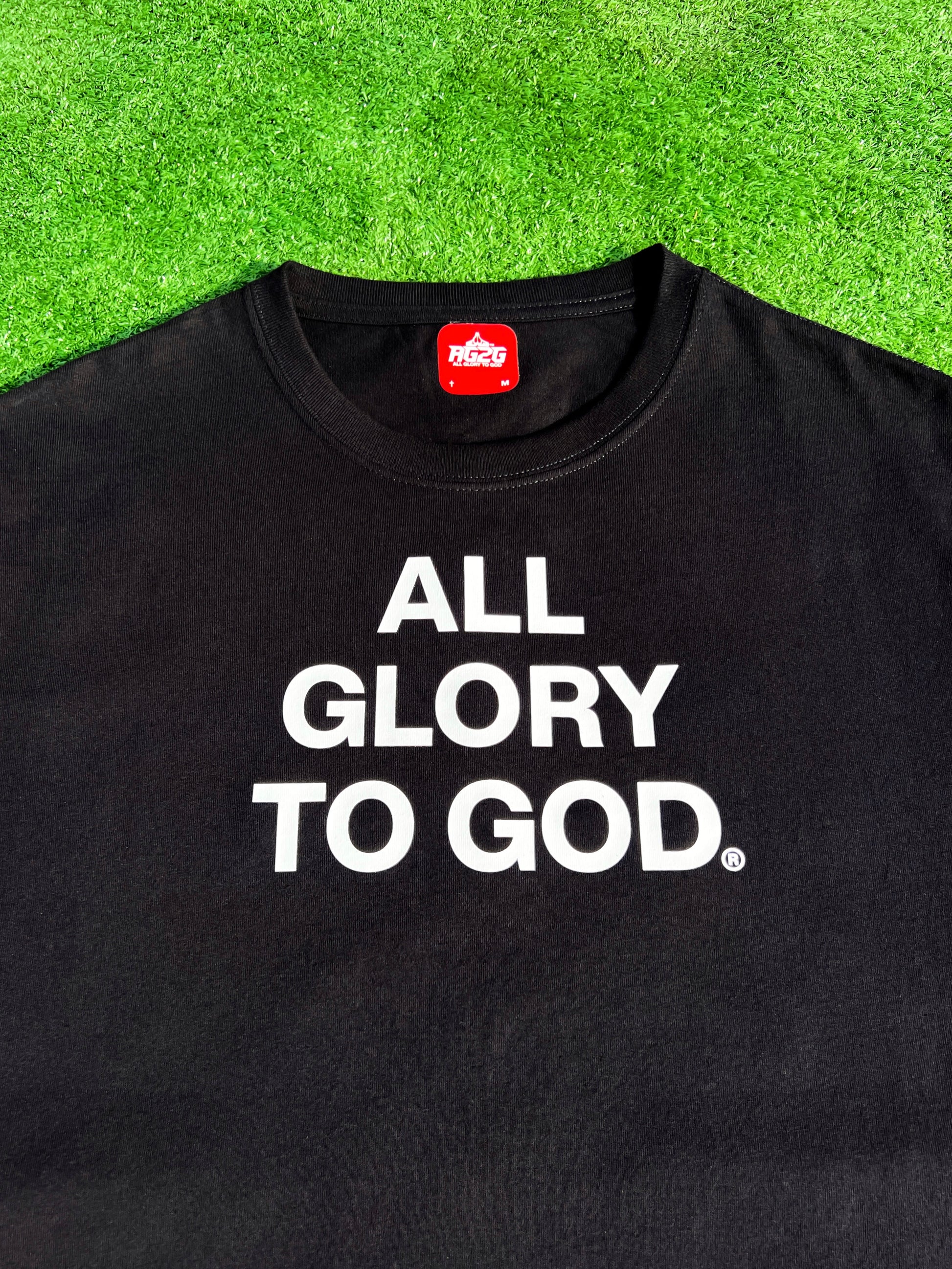 Christian Apparel: All Glory To God ‘Essential’ Tee in Black featuring bold lettering. Perfect for Christian t-shirts, Christian streetwear, and Christian athletic wear, blending faith, style, and comfort.